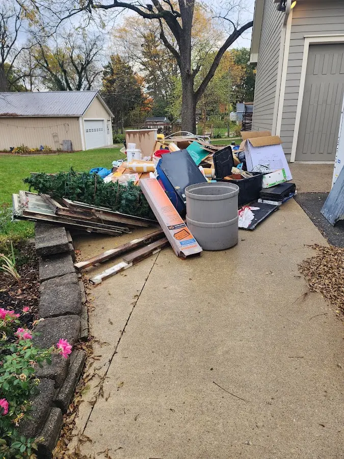 Dumpster being loaded with debris for Estate Cleanout Dumpster Rental in Westbrook